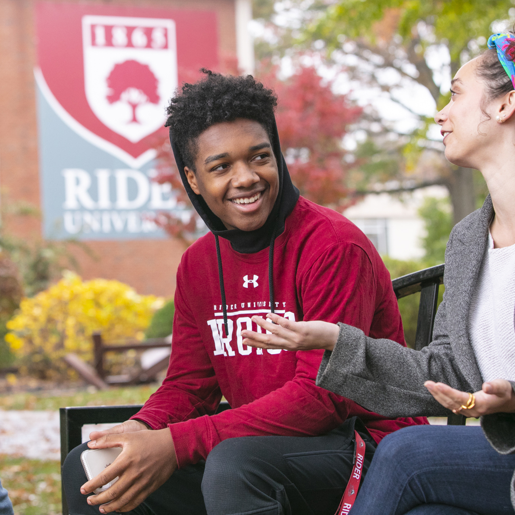Students sit outside on campus