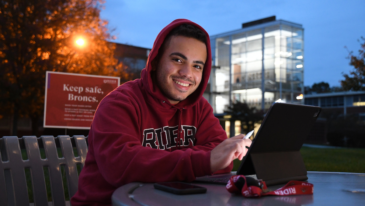 Student sitting on Sweigart Patio