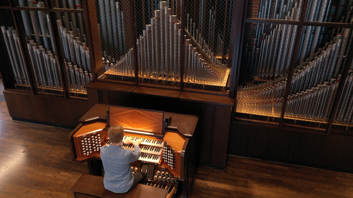 Student playing organ