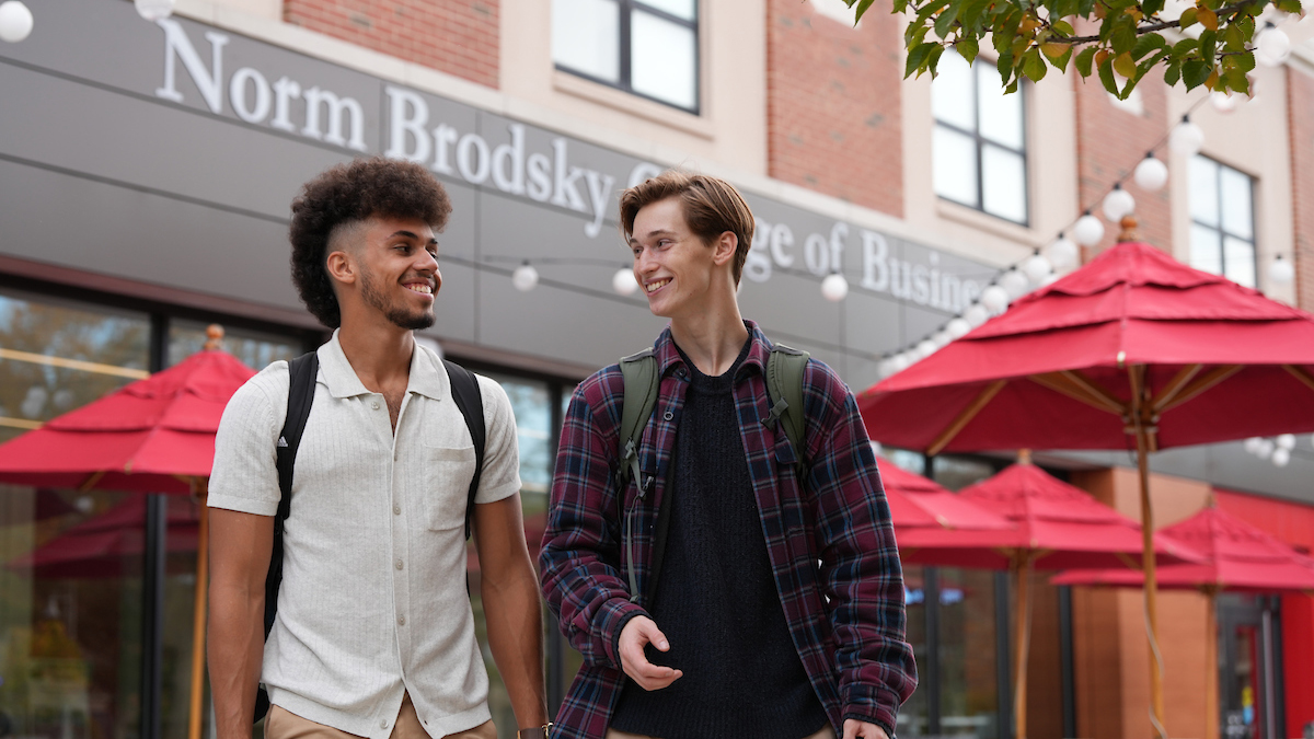 Rider students walk and talk outside the Norm Brodsky College of Business