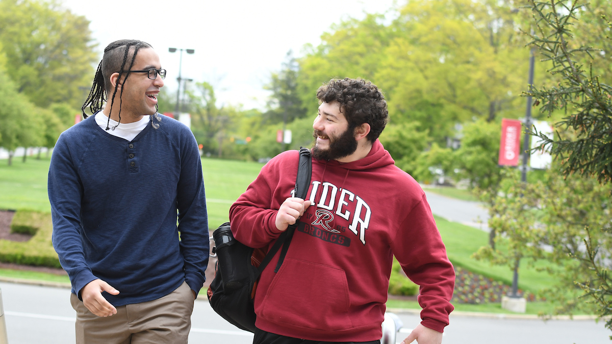 Two transfer students walking and chatting on Campus Mall