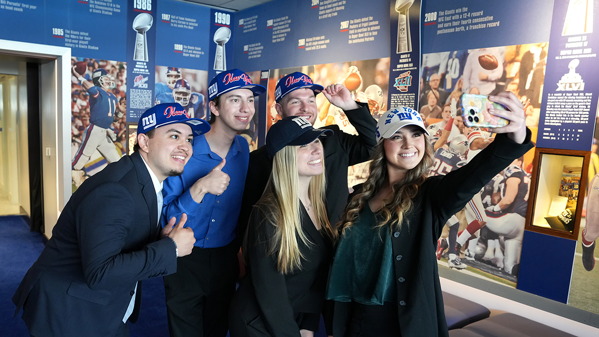 Students pose for selfie after presenting to Giants' front office staff