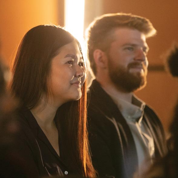 Students smile while listening to lecture