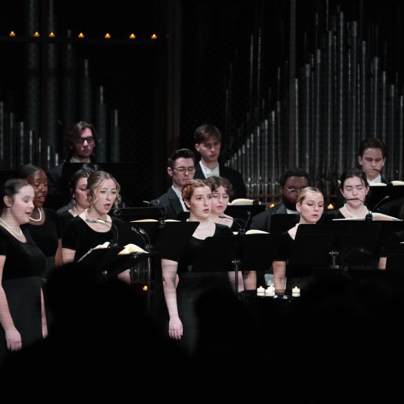 Students in black singing.