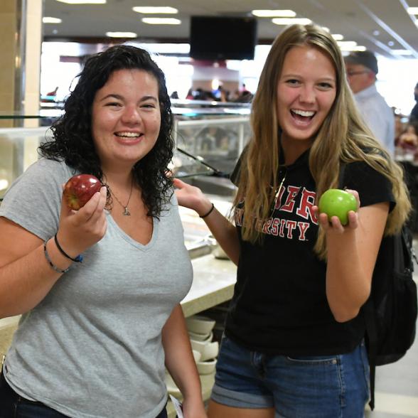Two students pose in Daly Dining Hall