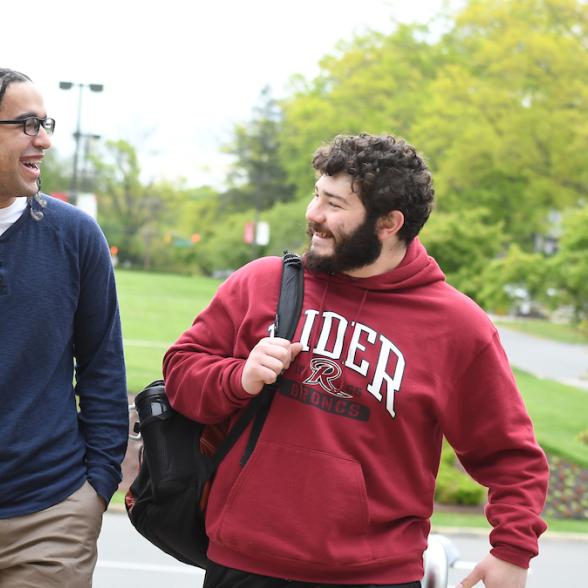 Two transfer students walking and chatting on Campus Mall