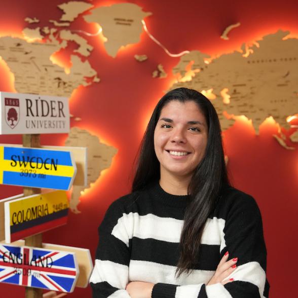 Rider students in front of world map and world flags