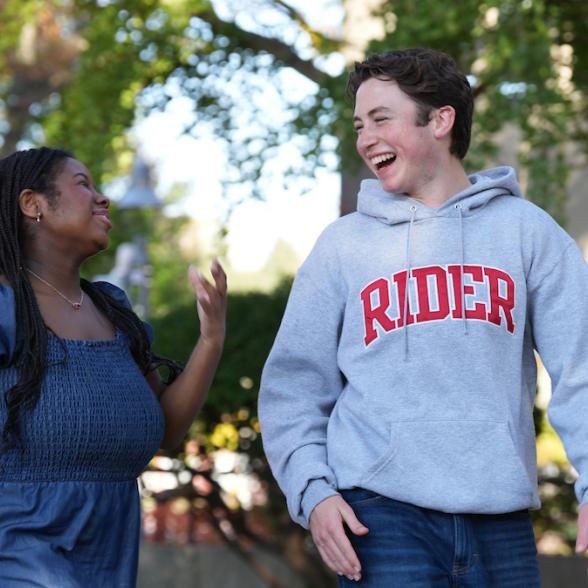 Two Rider students walking on campus laughing