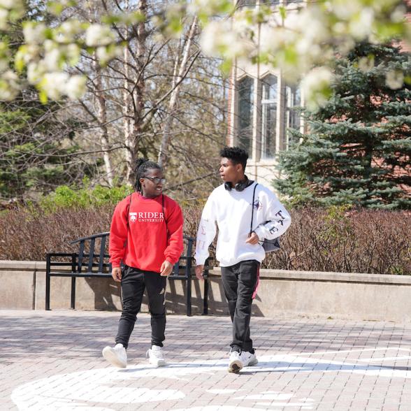 Two students walk near Moore Library