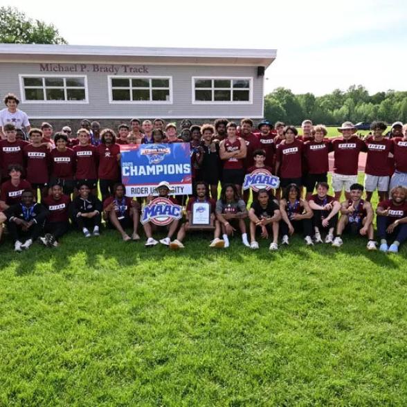 Men's track and field posing after win