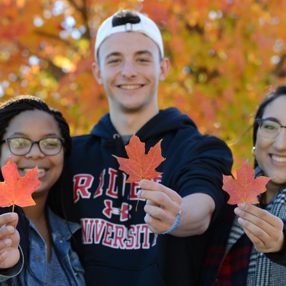 Rider students holding leaves