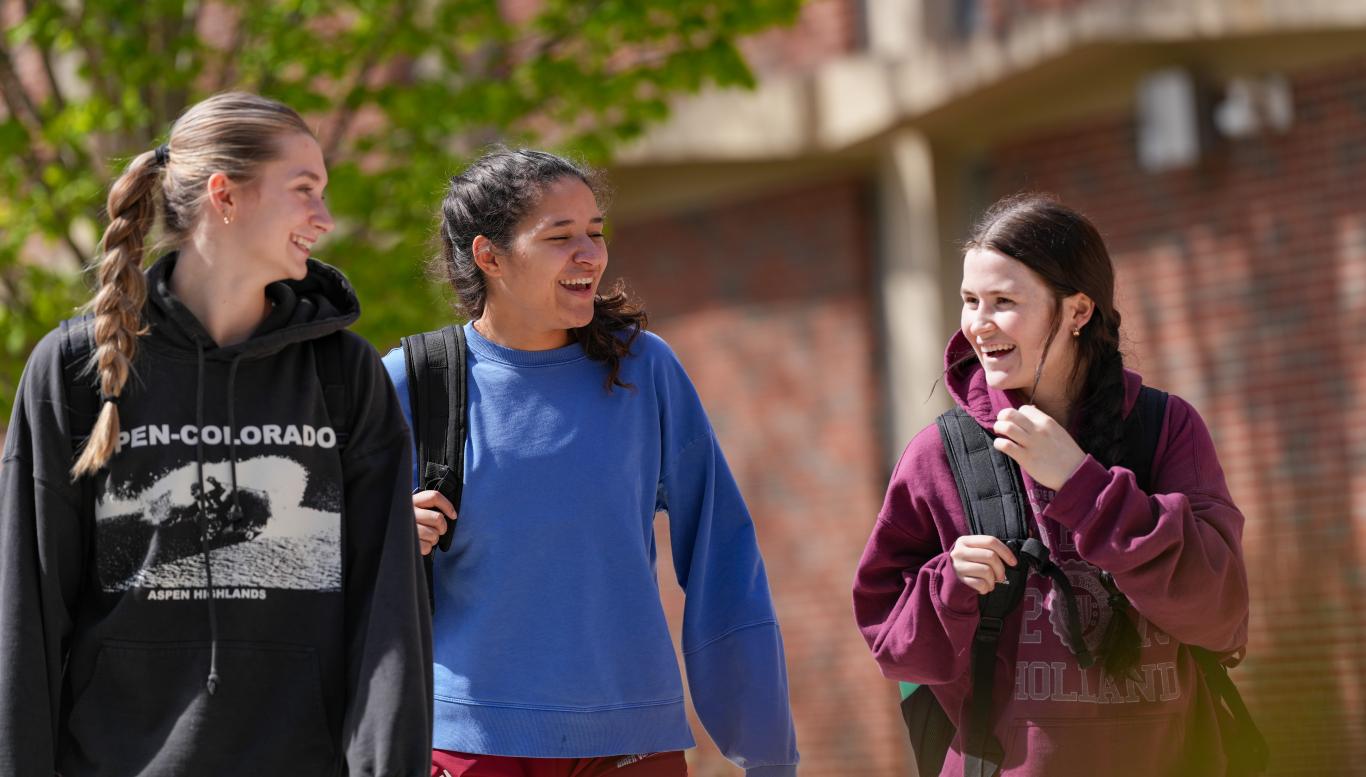 Smiling students outside on campus