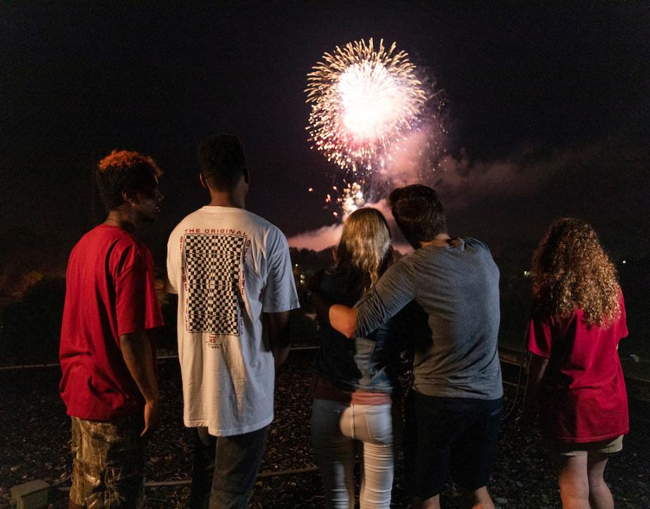 Group of students watch fireworks together.