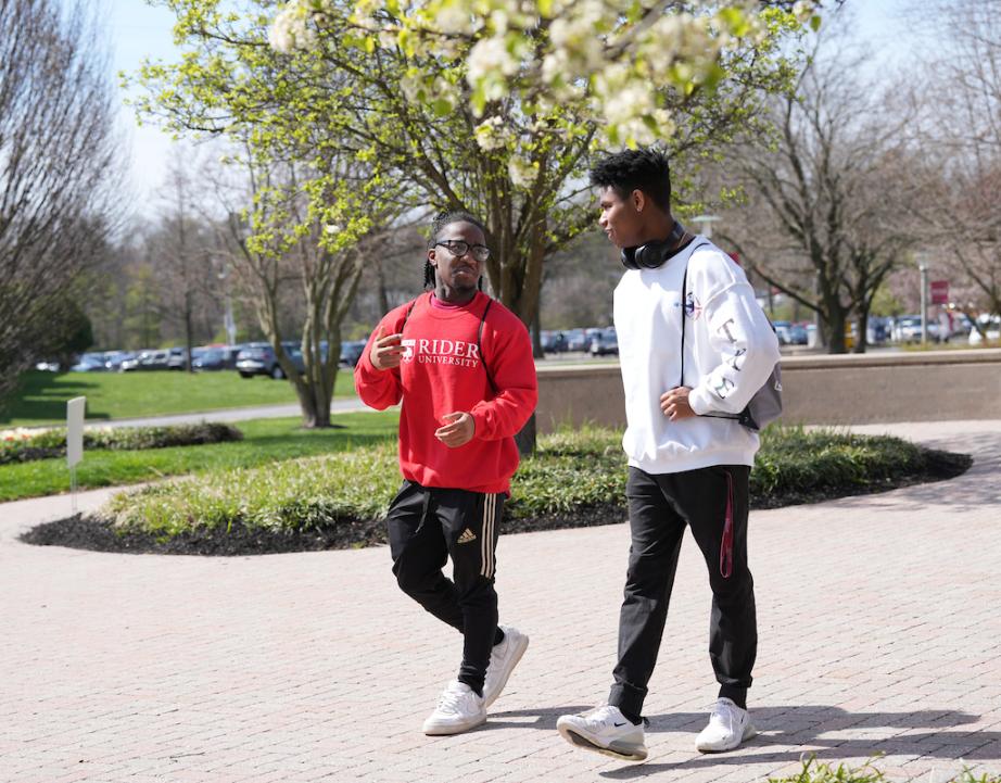 Two male students walk near library