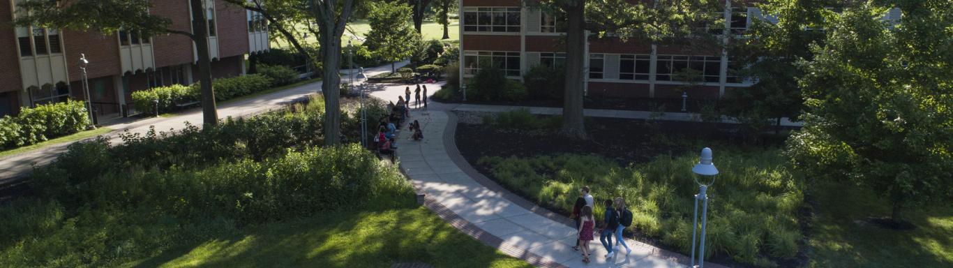 Groups of students walk outside on Rider campus.