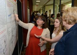 Students explain research at presentation.