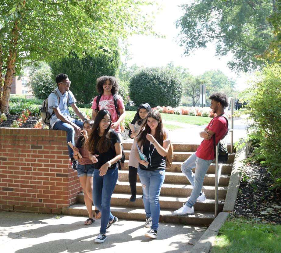 Students sit on steps on Rider campus.