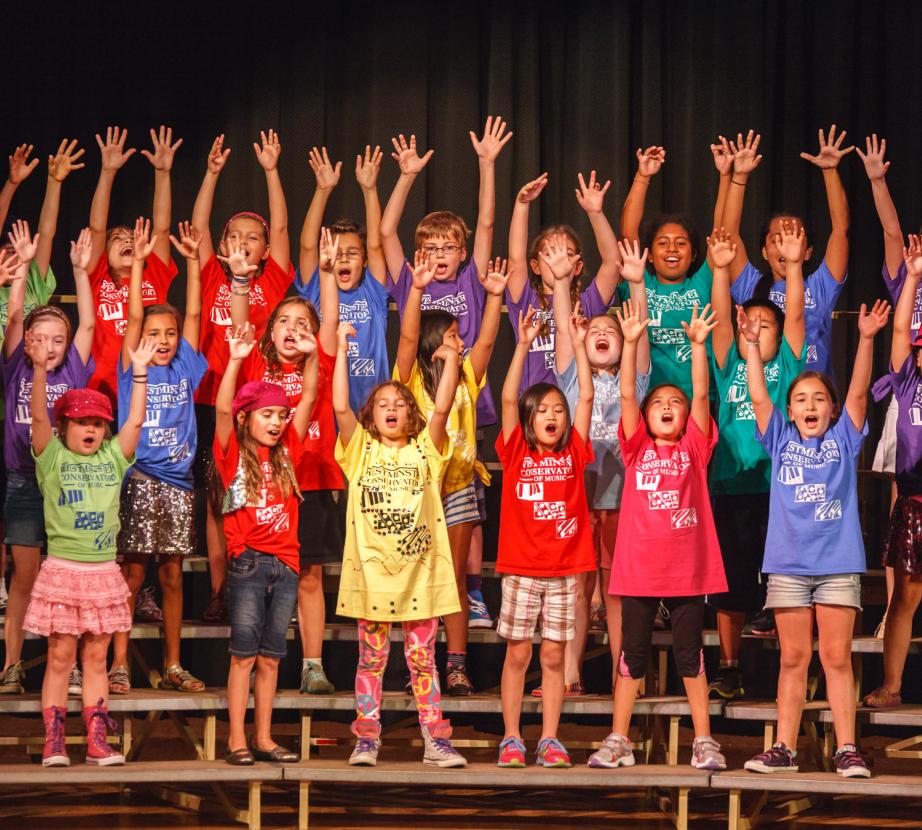 Summer Camp children reaching for the stars during a performance