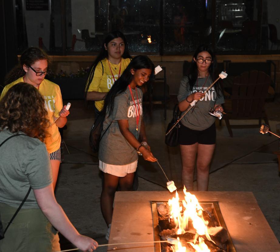 Students roasting marshmallows at orientation