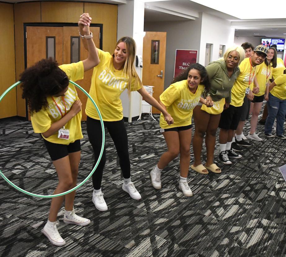 students at orientation with hula hoops
