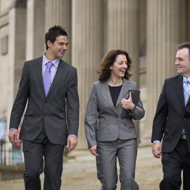 Graduate Students walking down the steps of a legal building