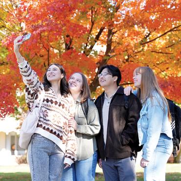 group of students posing for photograph on campus